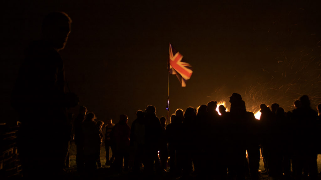 A group of people enjoying a bonfire on firework night